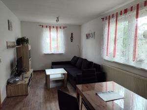 a living room with a couch and a table at Fewo Kretsche in Boxberg