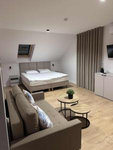 a living room with a couch and a bed at Widokówka Radostowa 