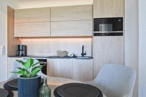 a kitchen with a table and a sink and a microwave at Fewo Gestrandet in Norderney