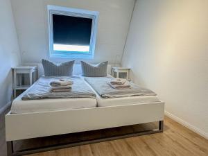 a bed in a small room with a window at Kaffeehaus - Fewo 3 in Norderney