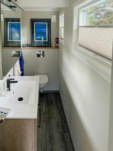 a bathroom with a white sink and a toilet at Fantastic Cabin With View Over Ytre Oslofjord in Gressvik