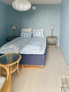 a bedroom with a large bed and a table at Fantastic Cabin With View Over Ytre Oslofjord in Gressvik