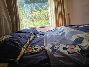 a bed with a blanket with a dog on it at Finca santa helena in Machetá +8 photos
