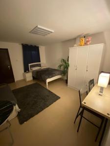 a large living room with a bed and a desk at Simple studio in Abu Dhabi in Abu Dhabi