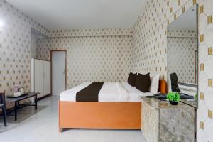 Ένα ή περισσότερα κρεβάτια σε δωμάτιο στο Hotel O Executive Inn