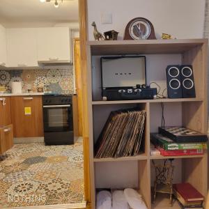 a kitchen with a book shelf with music equipment at Studio Catalin in Braşov