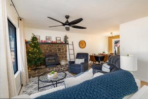 a living room with a couch and a fireplace at Whispering Pines: Foosball Grill More in Mountainaire
