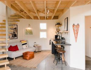 a living room with a couch and a table at Clark Farm Silos - 5 Silo Mountain View Retreat in Kalispell +42 photos