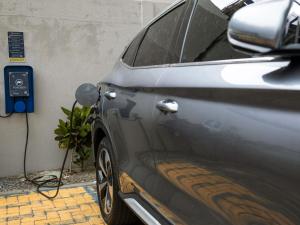 a car is plugged into a electric car charger at ibis budget Maceió Pajuçara in Maceió