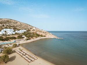 an aerial view of a beach with a group of chairs at Dolphin Bay Seaside Resort & Suites in Galissas