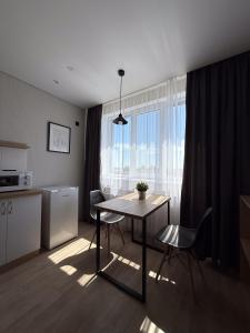 une cuisine avec une table et des chaises dans une pièce dans l'établissement Поділля, à Netishyn