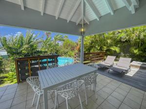 a patio with a table and chairs and a pool at GPSA82 - 4 pax in Fouché