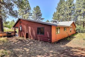 a log cabin in the woods with trees at Rare Log Cabin Treasure Close to Grand Canyon Now with Wi-Fi in Parks