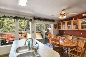 a kitchen and dining room with a table and a dining table at Gorgeous Historic 3 BR Log Cabin w Forest Views 20 Minutes from Flagstaff Now with Wi-Fi in Parks