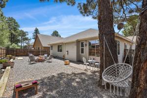 a backyard with a table and chairs and a house at Sublime Mountain Retreat Pool Table Fire-Pit Arcade Game Ideal Location w Central AC in Flagstaff