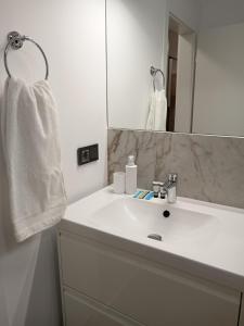 a bathroom with a white sink and a mirror at Zen aeroport confort in Sînnicoară +22 photos