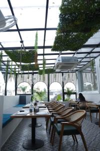 a restaurant with a table and chairs and windows at Hotel Amber Inn in Prayagraj