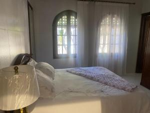 1 cama en un dormitorio con 2 ventanas en Tradition & Modernité, en Rabat