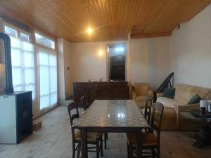 a living room with a table and a couch at Cazare La Cetate in Moşna