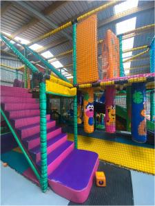a play room with purple and pink play equipment at The Wee Sprout in Stranraer