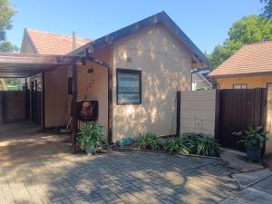 a house with a fence and a patio at The Converted Space in Welkom