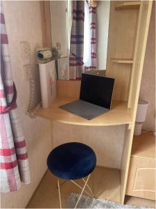 a toy desk with a laptop and a blue stool at The Wee Sprout in Stranraer