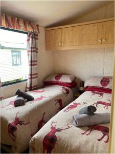 a bedroom with two beds with antlers on them at The Wee Sprout in Stranraer