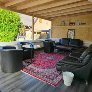 a living room with couches and a table and chairs at Gästehaus Bergedorf in Hamburg +44 photos