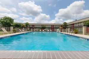 a large swimming pool in front of a hotel at Iberia House & Suites in New Iberia