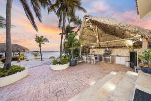 a resort patio with a view of the ocean at Private Beach Ocean Front Boat Dock Tiki Bar in Savaneta