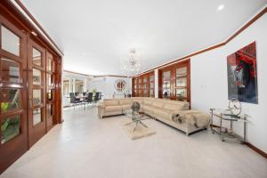 a living room with a couch and a table at Private Beach Ocean Front Boat Dock Tiki Bar in Savaneta