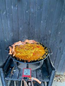 a pan of food on top of a grill at Traditional Scanian Farmhouse Near Sandhammaren Beach in Löderup