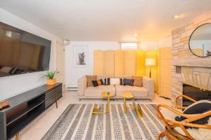 a living room with a couch and a fireplace at Private Riverside Retreat in Appleton +17 photos