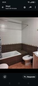 a bathroom with a bath tub and a toilet at La estrella del desierto in Tabernas +27 photos