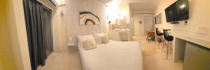 a bedroom with a white bed with pillows on it at CENTRAL VIEW ΜΙΔΕΙΑ in Levádeia +37 photos