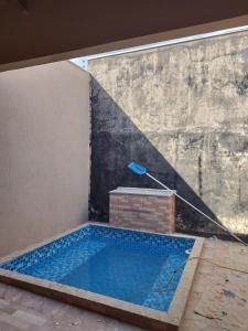 a swimming pool in a room with a large window at Casa Acqua Beach in Vilhena