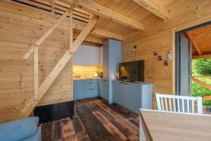 een keuken met houten wanden en een trap in een huis bij Korbielów 6 in Korbielów
