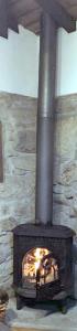 アルコス・デ・ヴァルデヴェスにあるCasa da Avóの石の壁と火のともった暖炉