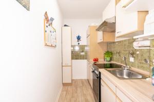 a small kitchen with a sink and a stove at Ferienwohnung Nolte Grömitz in Grömitz