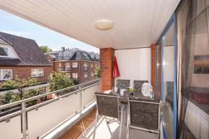 a balcony with a table and chairs on it at Ferienwohnung Nolte Grömitz in Grömitz +30 photos