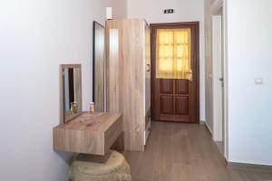 a bathroom with a wooden sink and a mirror at Oceanis apartment in Symi +21 photos