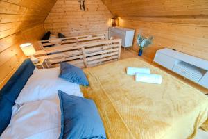 a bedroom with a large bed in a wooden cabin at Korbielów 6 in Korbielów