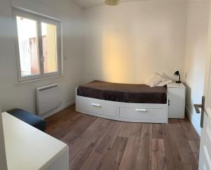 un dormitorio con una cama y una ventana en Chez Hughes, en Montaigut-sur-Save