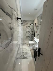 a bathroom with a toilet and a sink at Elegant Escapes 6 in Athens