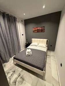 a bedroom with a bed with two shoes on it at Elegant Escapes 6 in Athens