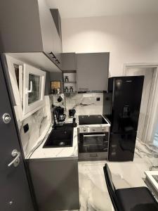 a kitchen with a black and white stove top oven at Elegant Escapes 6 in Athens