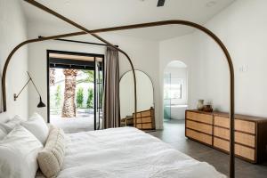 a bedroom with a large white bed and a mirror at The MYAH by Porter NEWLY REMODELED Enjoy the Pool Firepit Luxury in Phoenix +50 photos