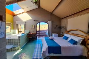 a bedroom with a large bed and a bathroom at Chalés São Francisco II in Santo Antônio do Pinhal +95 photos