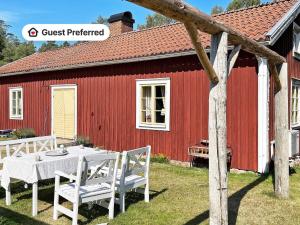 a table and chairs in front of a red building at 4 person holiday home in FURUBY in Furuby