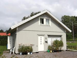 a white garage with a white door and a window at 4 person holiday home in ONSALA-By Traum in Onsala